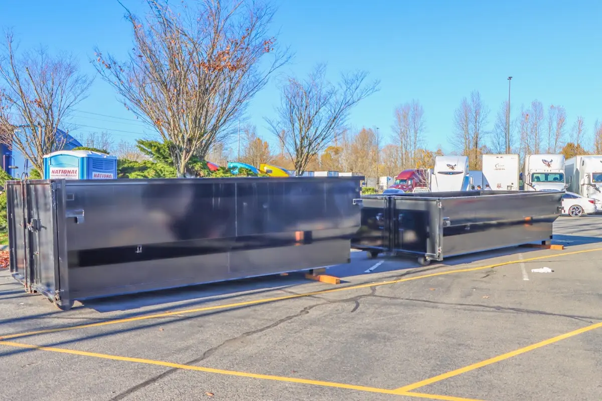 Professional dumpster rental service with roll-off container on residential driveway in Massapequa Park